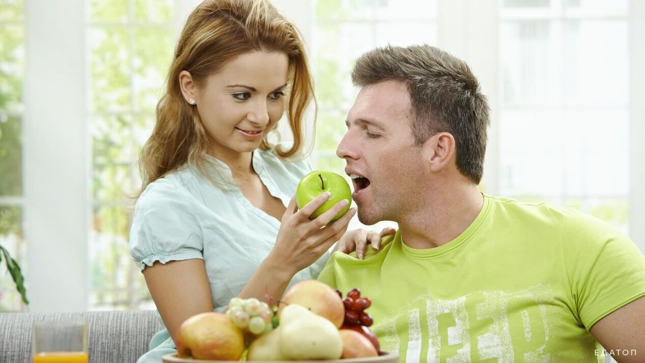 girl feeds man healthy food